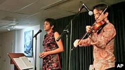 Irish violinist Colm O'Riain and his wife, Pireeni Sundaralingam, a Sri Lankan Tamil poet, performing together.