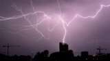 Flashes of lightning strike "La Cite du Vin" in Bordeaux, southwestern France, during a thunderstorm.