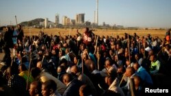 Miners on strike chant slogans as they march in Nkaneng township outside the Lonmin mine in Rustenburg, May 14, 2014. 