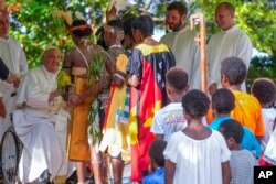 Pope Francis, left, meets with indigenous people at the Holy Trinity Humanistic School in Baro, near Vanimo, Papua New Guinea, Sept. 8, 2024.