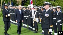 New Zealand Biden Visit: U.S. Vice President Joe Biden, center, inspects an honor guard during a ceremony at Government House in Auckland Thursday, July 21, 2016.