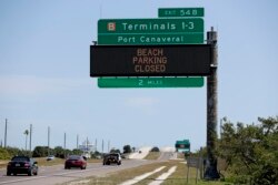 Informational signs near Port Canaveral warn motorists that all beach parking in Brevard County is closed April 4, 2020, in Cape Canaveral, Fla.