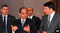 In this photo provided by Egypt's state news agency MENA, Egyptian President Abdel-Fattah el-Sissi, center, escorts Italian Prime Minister Matteo Renzi, right, to a joint press conference, in the presidential palace in Cairo, Aug. 2, 2014.