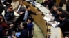 North Korean defectors, left, argue with North Korean diplomats, right, at United Nations headquarters as the diplomats try to make a statement during a panel discussion on North Korean human rights abuses, April 30, 2015.