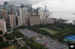 Tens of thousands of residents gather to march in downtown streets during an annual pro-democracy protest in Hong Kong Tuesday, July 1, 2014. Hong Kong residents began marching through the streets of the former British colony to push for greater democracy