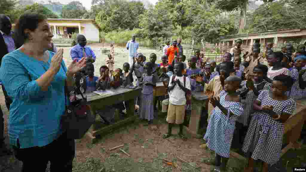 Students welcome United Nations Children's Fund (UNICEF) Ivory Coast Representative Adele Khudr as she arrives for a Ebola awareness drive in Gueupleu, Man, in western Ivory Coast, Nov. 3, 2014. 
