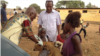 Children bring their dogs for a free vaccination, Freetown, Sierra Leone, April 12, 2015 (Nina deVries/VOA)