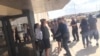 People are evacuated from an Odessa movie theater following a shooting in Odessa, Texas, in this still image taken from social media video Aug. 31, 2019. 
