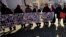 FILE - Members of the Srebrenica Women Union hold photographs of the 1995 Srebrenica massacre dead and missing in Tuzla, Bosnia, Nov. 11, 2017. The Balkan nations that fought bitter wars as the former Yugoslavia crumbled in the 1990s signed an agreement Nov. 6, 2018, to enhance their cooperation in identifying thousands of people still missing as a result of the conflicts.