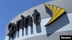 FILE - A Sprint store sign is shown in El Cajon, California, Aug. 8, 2017.