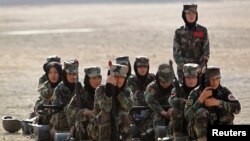 Afghan National Army (ANA) female officers watch a training exercise at the Kabul Military Training Centre (KMTC) in Kabul, October 8, 2013. REUTERS/Omar Sobhani (AFGHANISTAN - Tags: MILITARY) - RTX143OO