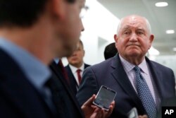 FILE - Agriculture Secretary Sonny Perdue listens to a question from a reporter after testifying on the FY2019 USDA budget request, April 11, 2018, on Capitol Hill in Washington.