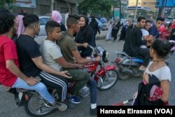 FILE - A young girl reacts to harassment from a group of young men on motor bikes during Eid Al-Fitr in Cairo, Egypt, June 15, 2018.