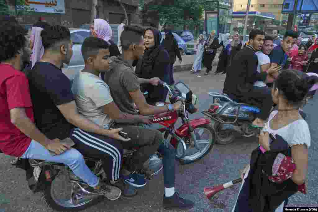 A young girl reacts to harassment from a group of young men on motorbikes during Eid Al-Fitr in Cairo, June 15, 2018.