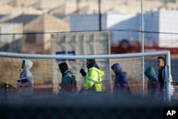 Teen migrants walk in line inside the Tornillo detention camp in Tornillo, Texas, Dec. 13, 2018.