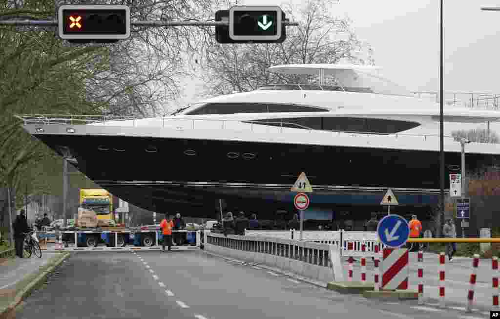 The yacht MY 98 is carried by a truck to the fairground in Düesseldorf, Germany. The boat of the British Princess shipyard with a length of 30 meters (90ft) weighs 100 tons, worth around 7 million euro ($8.3 million), and will be on display at the international boat fair in Düesseldorf from Jan. 17 until Jan. 25, 2015.