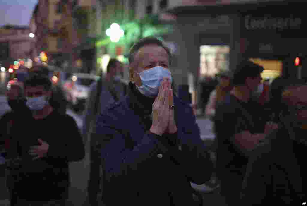 A man prays in the street outside the Notre Dame church in Nice, southern France, after a knife attack.