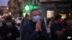 A man prays in the street outside the Notre Dame church in Nice, southern France, after a knife attack. (AP Photo/Daniel Cole)