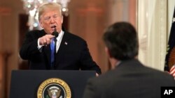 President Donald Trump points to CNN's Jim Acosta as he speaks during a news conference in the White House, in Washington, Nov. 7, 2018. 