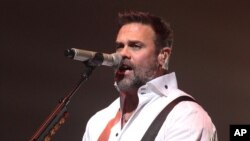 FILE - Troy Gentry of the country music duo Montgomery Gentry performs on the Rebels On The Run Tour at the American Music Theatre in Lancaster, Pa., Jan. 17, 2013.