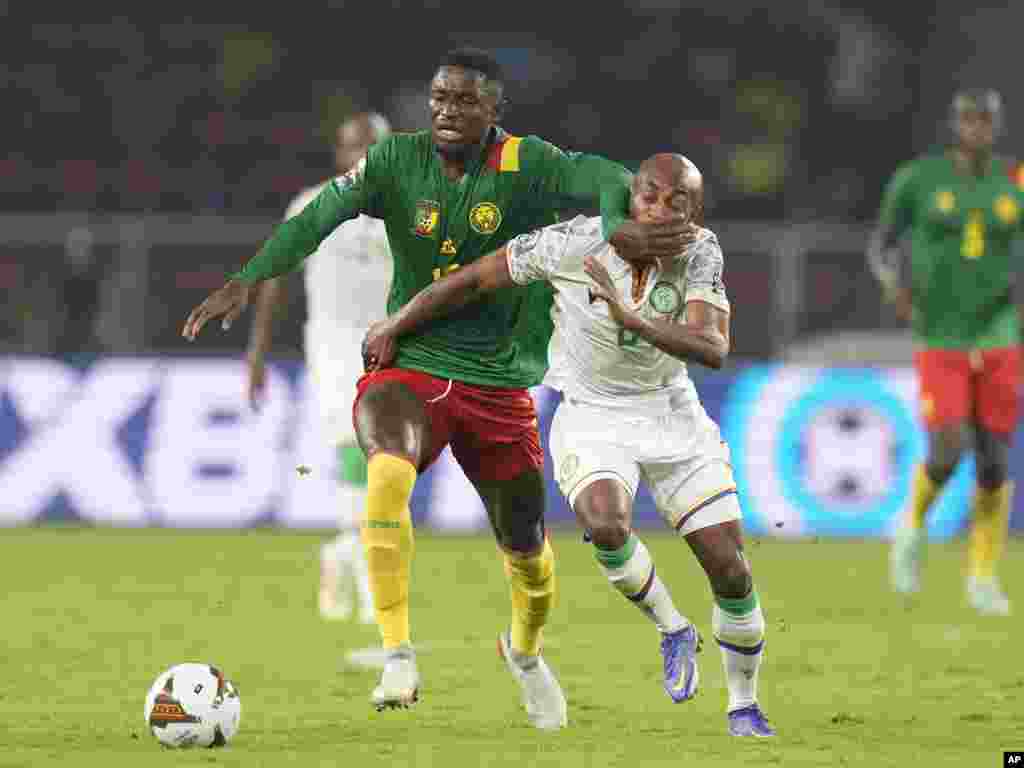 Comoros' Fouad Bachirou, right, is challenged by Cameroon's Martin Hongla.