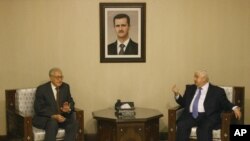 Lakhdar Brahimi, the U.N.-Arab League envoy to Syria, left, meets with Syrian Foreign Minister Walid Moallem, right, in Damascus, Syria, September 13, 2012.
