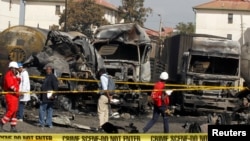 Forensic experts from the Directorate of Criminal Investigations, DCI arrive at the scene of an explosion at a makeshift gas cylinder refilling depot in Mradi estate, Embakasi district, in Nairobi, Kenya, February 2, 2024.