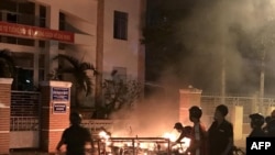 Picture taken on June 10, 2018 shows protesters burning motorcycles in front of a provincial office in Vietnam's south central coast Binh Thuan province in response to legislation on three special economic zones that would grant 99-year leases.