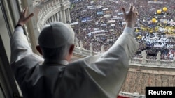 Pope Benedict waves to the crowd gathered in St. Peter's square during his weekly Angelus blessing at the Vatican, May 16, 2010.