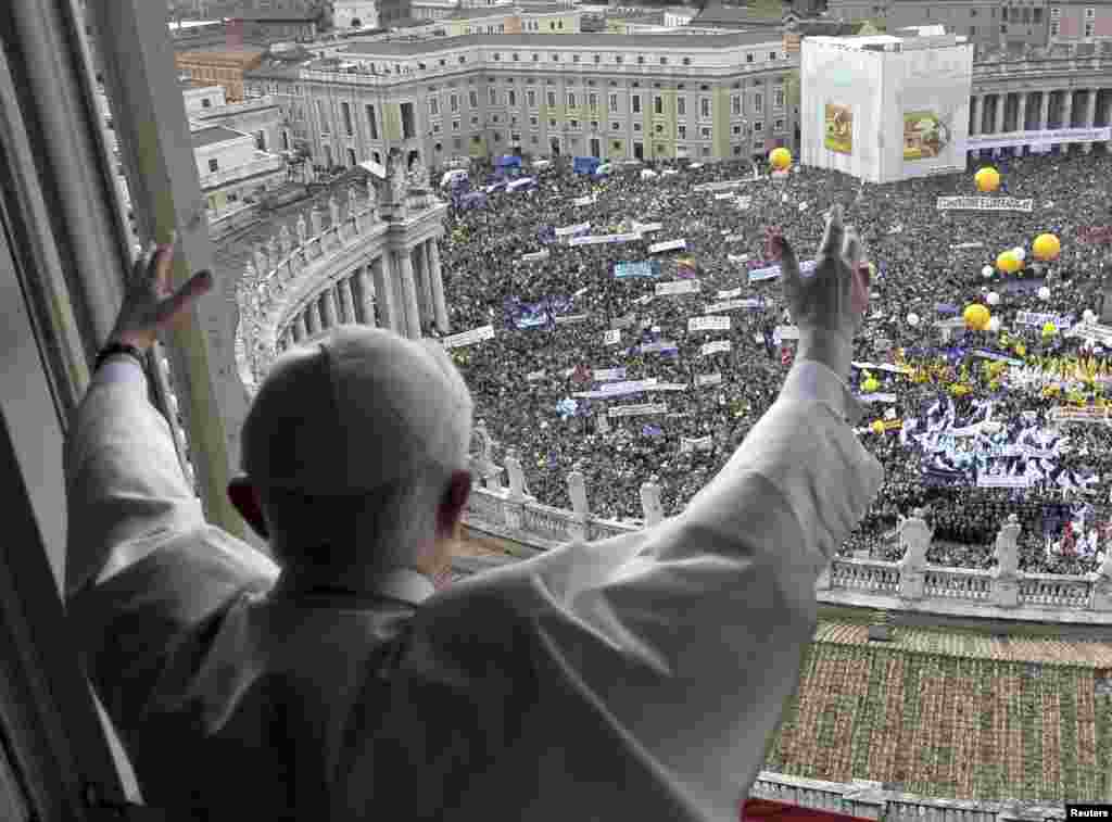 Pope Benedict waves to the crowd gathered in Saint Peter's square during his weekly Angelus blessing at the Vatican, May 16, 2010.