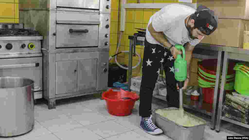 Hassan Mansour from Aleppo, Syria, prepares a daily meal at the Khora center, in the Exarchia district in Athens, Greece, Oct. 24, 2016.