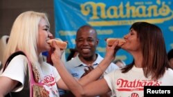 Does this include competitive eaters? Champion Miki Sudo (L) poses with competitor Michelle Lesco during the official weigh-in ceremony for the Nathan's Famous Fourth of July International Hot Dog-Eating Contest in Brooklyn, New York, July 1, 2016. (REUTERS/Andrew Kelly)