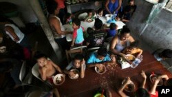 FILE - In this May 30, 2019 file photo, Honduran migrant children eat a meal at the Jesus el Buen Pastor del Pobre y el Migrante shelter in Tapachula, Chiapas state, Mexico. 