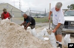 Gulfport, Miss., residents shovel sand into bags at a Harrison County Road Department sand bagging location, while preparing for Subtropical Storm Alberto to make its way through the Gulf of Mexico, May 26, 2018.