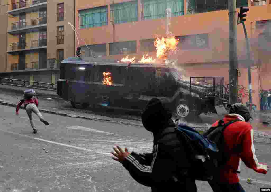 A police vehicle burns during a protest against Ecuador President Lenin Moreno&#39;s austerity measures, in Quito, Oct. 7, 2019.