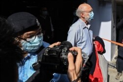 FILE - John Clancey, a U.S. solicitor with law firm Ho Tse Wai and Partners that is known for taking on human rights cases, is arrested under a new national security law in the Central district in Hong Kong, Jan. 6, 2021.