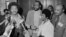 FILE - The Rev. Jesse Jackson speaks to reporters at the Operation PUSH Soul Picnic in New York, March 26, 1972, as Tom Todd, vice president of PUSH, from second left, Aretha Franklin and Louis Stokes look on.