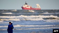 The Danish tug supply vessel 'Assister' is seen off Blokhus beach as it sails along the west coast of North Jutland to localise and retrieve containers, on December 26, 2023.