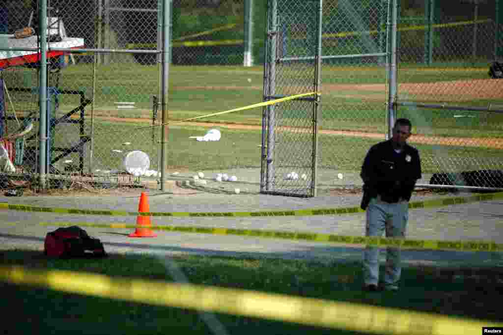 A police officer mans a shooting scene after a gunman opened fire on Republican members of Congress during a baseball practice near Washington in Alexandria, Virginia, June 14, 2017.