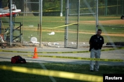 A police officer mans a shooting scene after a gunman opened fire on Republican members of Congress during a baseball practice near Washington in Alexandria, Virginia, June 14, 2017.