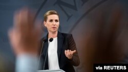 FILE -Denmark's Prime Minister Mette Frederiksen speaks at a COVID-19 news conference, in Copenhagen, Denmark, Sept. 18, 2020. Frederiksen announced a lockdown to begin Friday.