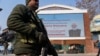 An Indian paramilitary soldier patrols near an electronic display in Srinagar, welcoming the Indian Prime Minister Narendra Modi to inaugurate a strategic tunnel project that connects Kashmir with Ladakh, Jan.13, 2025.