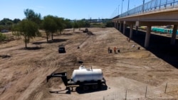 FILE - Crews clear an area used by migrants, many from Haiti, as an encampment along the Del Rio International Bridge, Sept. 24, 2021, in Del Rio, Texas.