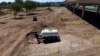 Crews clear an area that had been used by migrants, many from Haiti, as an encampment along the Del Rio International Bridge, Sept. 24, 2021, in Del Rio, Texas.