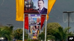 Billboards showing presidents of Azerbiajan, Kazakhstan and Turkey on a main highway to welcome them in Islamabad, Pakistan, Feb. 28, 2017.