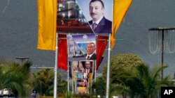 Billboards showing presidents of Azerbiajan, Kazakhstan and Turkey on a main highway to welcome them in Islamabad, Pakistan, Feb. 28, 2017.