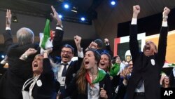 FILE: Mayor of Milan Giuseppe Sala, right, and members of the Milan-Cortina delegation celebrate after winning the bid to host the 2026 Winter Olympic Games, in Lausanne, Switzerland, June 24, 2019.