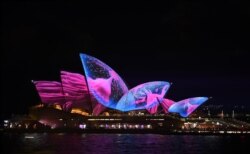 FILE - A light show called "Vivid" changes the appearance of the Sydney Opera House in Sydney, Australia, May 26, 2017.