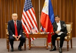 FILE - U.S. President Donald Trump, left, and Philippine President Rodrigo Duterte hold a bilateral meeting on the sidelines of an ASEAN Summit in Manila, Philippines, Nov. 13, 2017.
