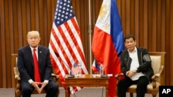 FILE - U.S. President Donald Trump, left, and Philippine President Rodrigo Duterte hold a bilateral meeting on the sidelines of an ASEAN Summit in Manila, Philippines, Nov. 13, 2017. 